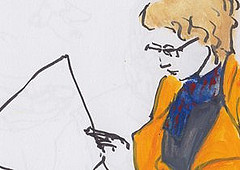 Woman in orange coat reading